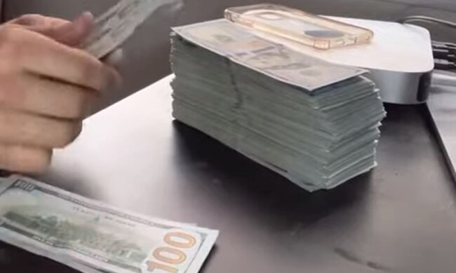 Доллары. Фото: скриншот YouTube-видео