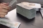 Доллары. Фото: скриншот YouTube-видео